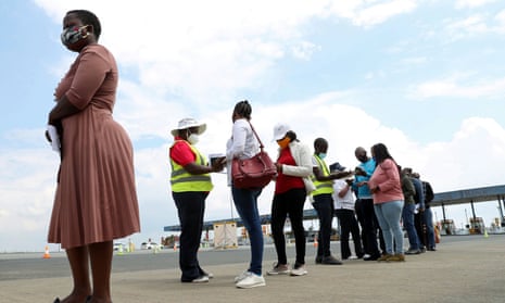 Travellers wait in a queue for coronavirus tests at the Grasmere Toll Plaza, Lenasia, South Africa.