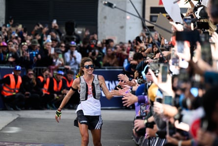 New Zealand’s Ruth Croft celebrates with supporters as she wins the Ultra Trail du Mont Blanc (UTMB), a 174km trail race crossing France, Italy and Switzerland in Chamonix, south-eastern France, on 30 August 2025. (Photo by JEFF PACHOUD / AFP)