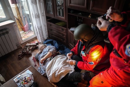 Paramedics treat an elderly woman wounded by shelling before transferring her to a maternity hospital converted into a medical ward, 2 March
