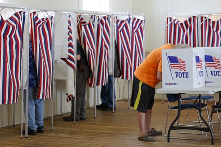 People voting in booths.