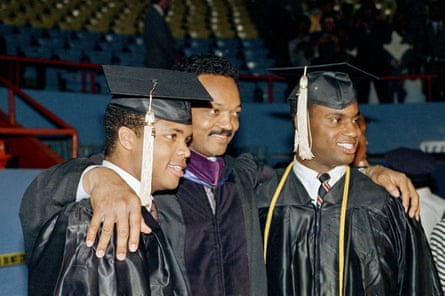 Three Black men smile for a photo.