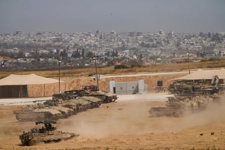 Israeli soldiers work on tanks and armoured vehicles near the border with the Gaza Strip in May.