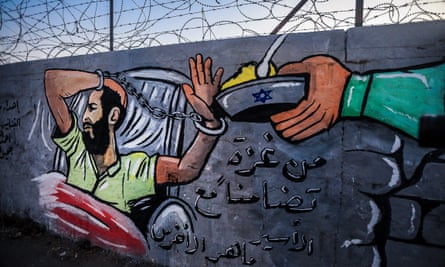 A mural depicts Akhras’s hunger strike on a wall at Al-Nuseirat refugee camp in the Gaza Strip