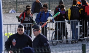 Some young migrants wait to leave the Calais camp