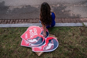 A woman rests next to anti-abortion posters in Washington.