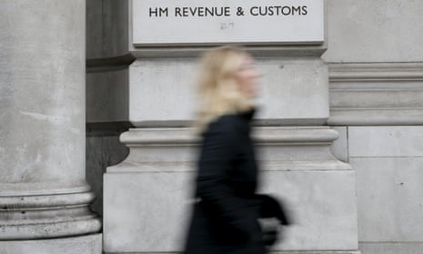 A pedestrian walking past the headquarters of HMRC
