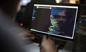 male sitting at computer screen