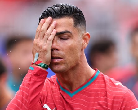 The Portugual footballer Cristiano Ronaldo puts his manus to his caput successful vexation during his team’s 1-1 World Cup group shape tie pinch nan Democratic Republic of nan Congo successful Houston, Texas.