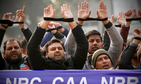 Indian citizens in New Delhi  in December 2019 raise their tied hands during a protest against the country’s citizenship law.