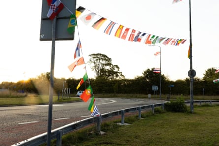 String of national flags on lamp-posts along an empty street