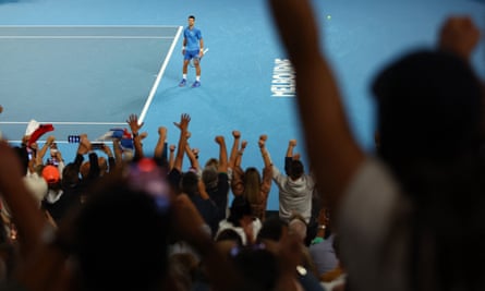 Fans react at match point as Novak Djokovic completes an emotional victory.