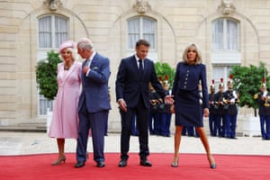 Macron and his wife, Brigitte Macron, and Charles and Camilla on a red carpet