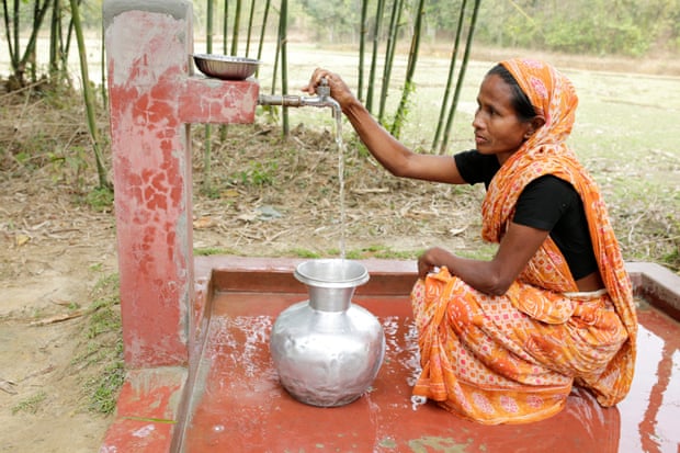 Bina Patrou, a tea picker at the Gulni tea estate, collects water from a pump installed by WaterAid and partners.