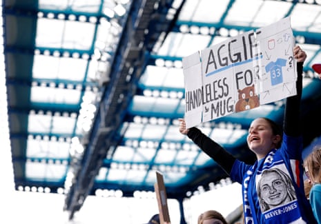 A Chelsea fan holds an Aggie Beever-Jones banner.