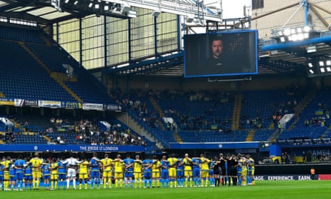 Ukraine's president Volodymyr Zelensky addresses the players and crowd from a giant screen ahead of the Game4Ukraine fundraising football match at Stamford Bridge on 5 August.
