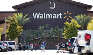Shoppers wear face masks in the parking lot of a Walmart in Rosemead, California, this month.