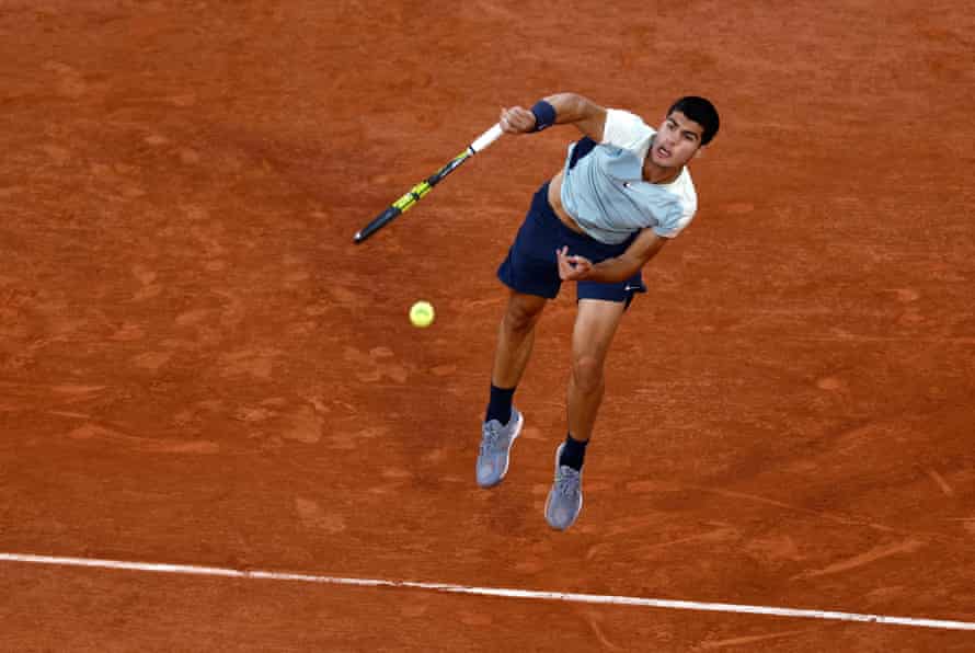 Carlos Alcaraz serves Sebastian Korda in their third-round match