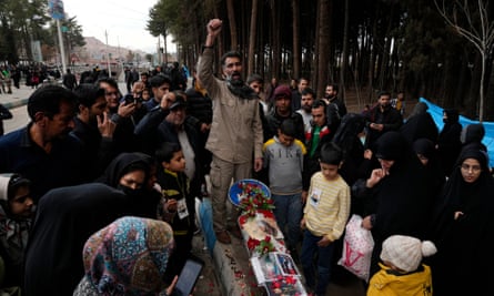 A man leads a chant at a makeshift memorial in Kerman