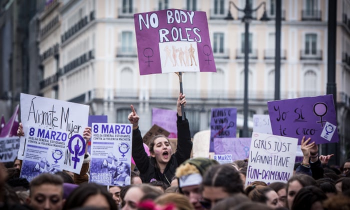 Demonstrators hold placards as they protest during a one day strike to defend women's rights on International Women's Day in Madrid.
