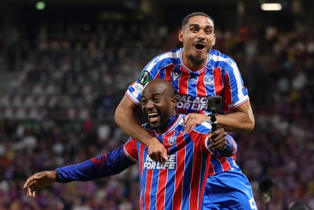 Maxence Lacroix jumps on Jean-Philippe Mateta as they celebrate winning the Conference League