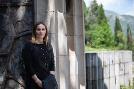 Edita Vučić leaning against a wall in the park