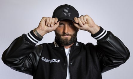 In a photo provided by LIV Golf, Jon Rahm poses with a hat branding the tour’s logo