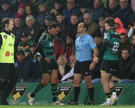 Injured Alex Mitchell walks off the pitch as a substitute enters