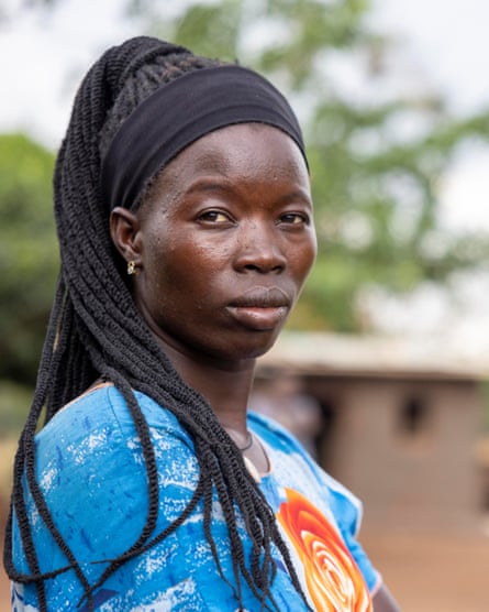 A young African woman looks at the camera