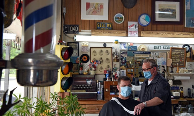 A man gets a haircut at Doug’s Barber Shop in Houston. Harris county, which includes Houston, has 157 virus cases per 100,000 people.