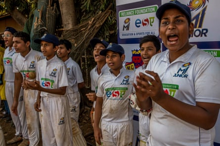 A player shouts encouragement to his team which bats during a match in the MI Junior inter-school tournament on Azad Maidan in Mumbai.