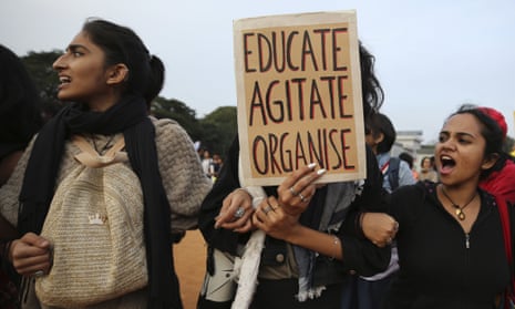 Indian students shout slogans and hold placards during a protest in Bangalore, India. 
