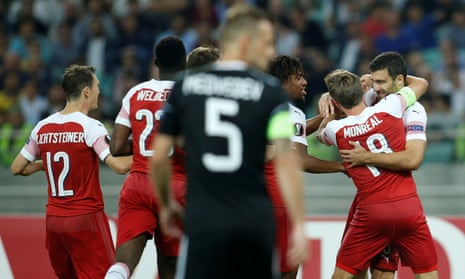 Sokratis Papastathopoulos (far right) is congratulated by his teammates after putting Arsenal ahead in Baku.