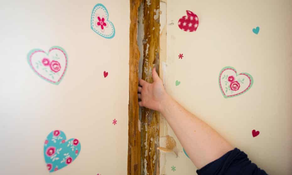 A resident of Bromyard House, on the Ledbury estate in south London, shows the extent of structural damage to her flat.
