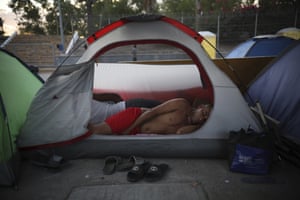 A Cuban migrant sleeps inside a tent at the foot of the Puerta Mexico bridge that crosses the border to Texas