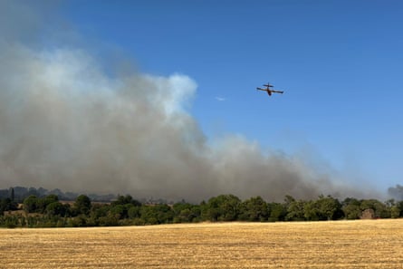 A Canadair CL-415 aircraft flies over a fire near Carcassonne, southern France