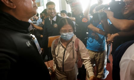 Nattawaree Moolkan walks through a crowd at the airport in Bangkok.