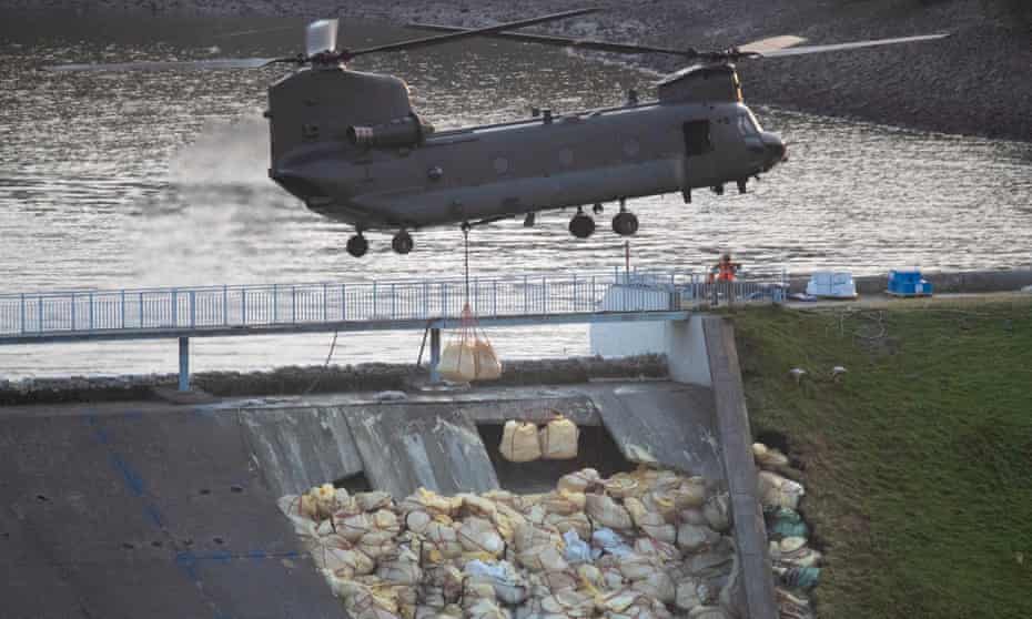An RAF helicopter drops bags of aggregate to help shore up a broken dam wall on the reservoir above Whaley Bridge last month.