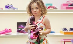 Girl holding shoes in shoe shop