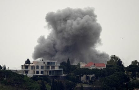 Smoke rises from behind buildings