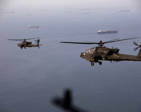 This handout photo released by US Central Command via their X account shows AH-64 Apaches flying above the Strait of Hormuz during a patrol on 17 April 2026.
