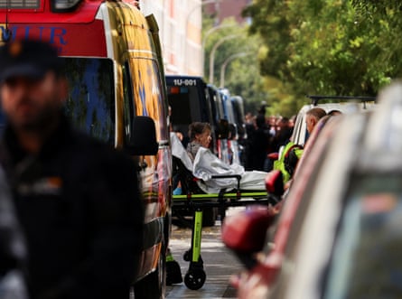 Maricarmen Abascal is transported between vehicles on a stretcher.