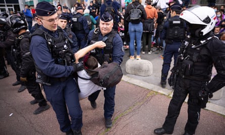 Police detain protesters outside Amundi’s offices