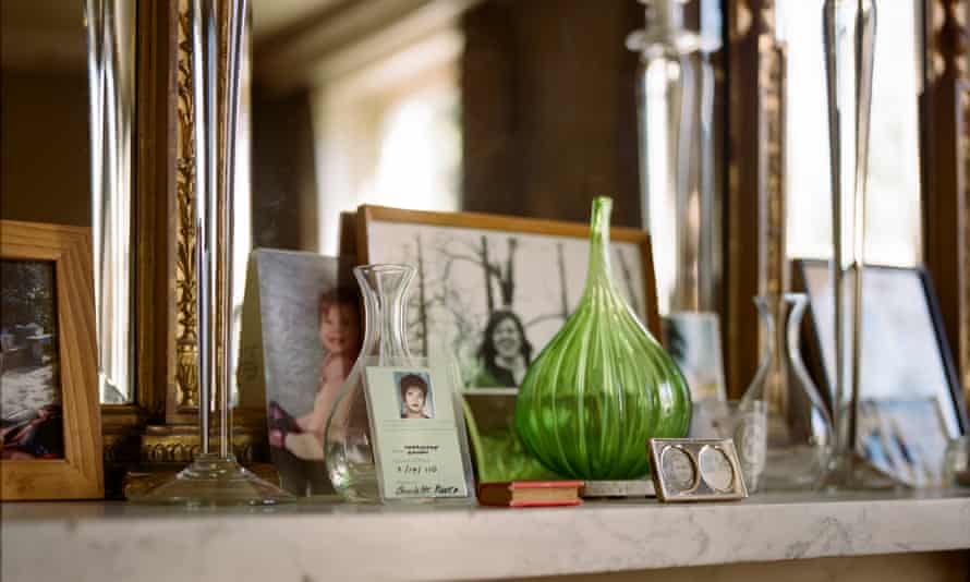 Photographs and glass vases on the mantelpiece in Charlotte Raven's house in London, Sept 2021