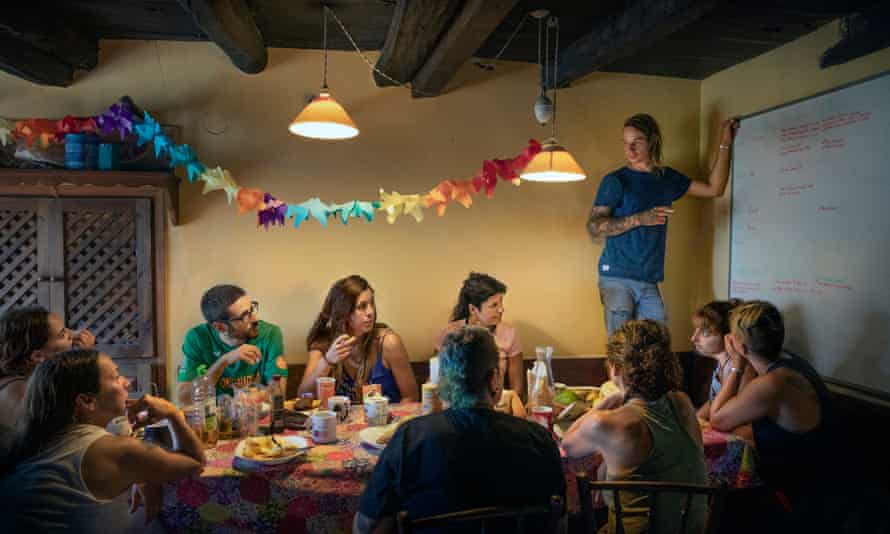 Residents and short-term volunteers have breakfast at El Hogar animal sanctuary in Spain