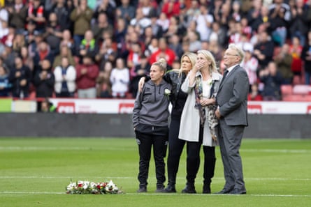 The Sheffield United womenâÂÂs captain Sophie Barker, Deborah Cusack, mother of Maddy Cusack, MaddyâÂÂs sister and the former Sheffield United player Tony Currie stand next to a wreath laid in the centre circle of Bramall Lane to mark the death of Maddy Cusack.