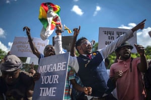 People chant anti-Mugabe slogans as they gather in Unity Square, opposite the parliament building