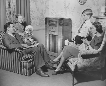 family around radio in vintage black and white photo
