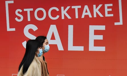 Two women walk past a sale sign in a department store window in Melbourne’s CBD on Wednesday as Australia entered its first recession in nearly three decades.