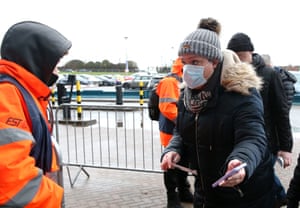 Fans have their Covid-19 passes checked as they arrive at the Coventry Building Society Arena for the Emirates FA Cup third round match between Coventry City and Derby County.