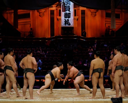 A stable of young fighters practise on the dohyo before action starts